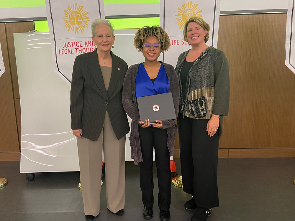 Joy Nash posing with her scholarship award