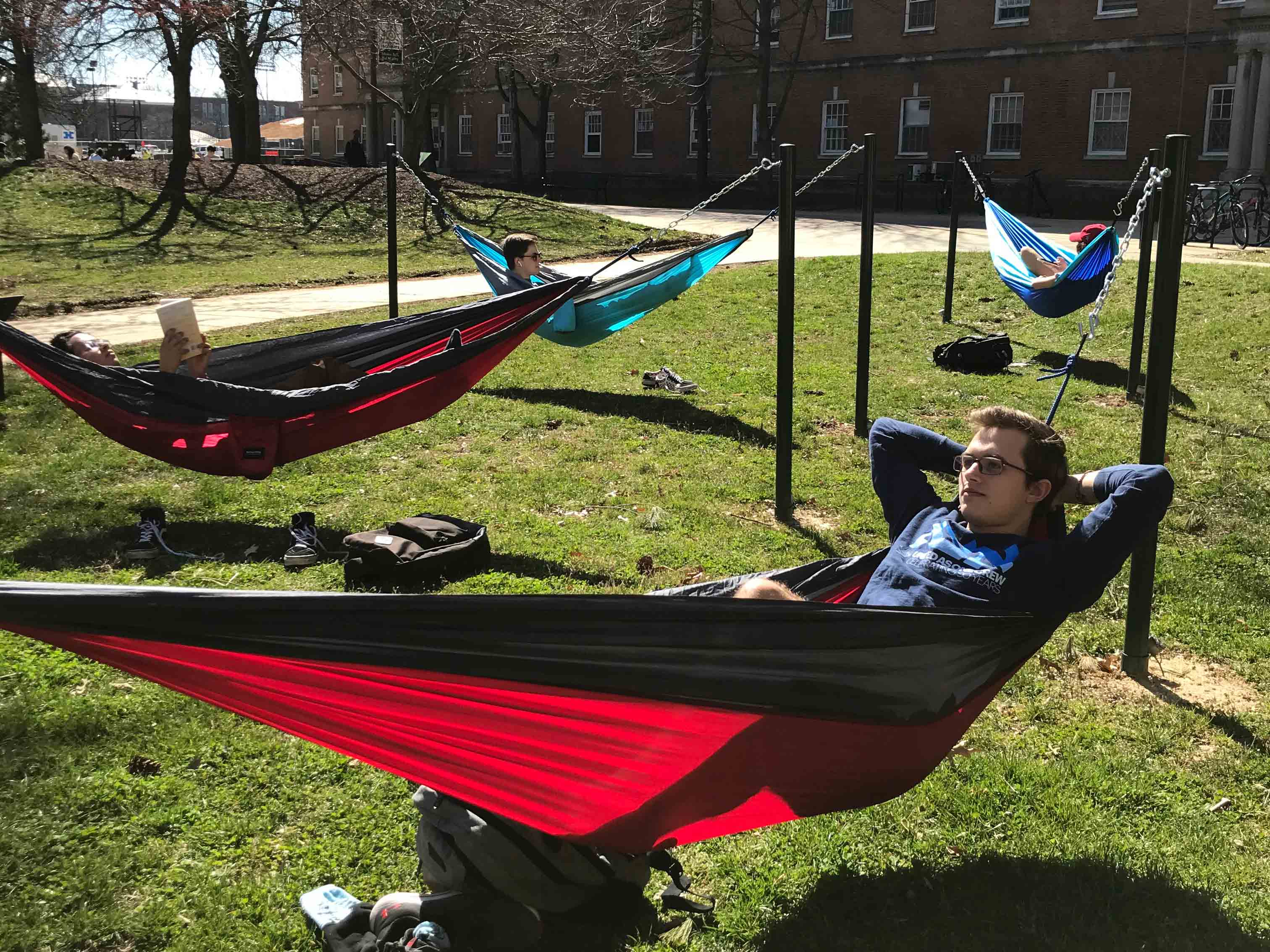 Students lie in hammocks in Cambridge Community