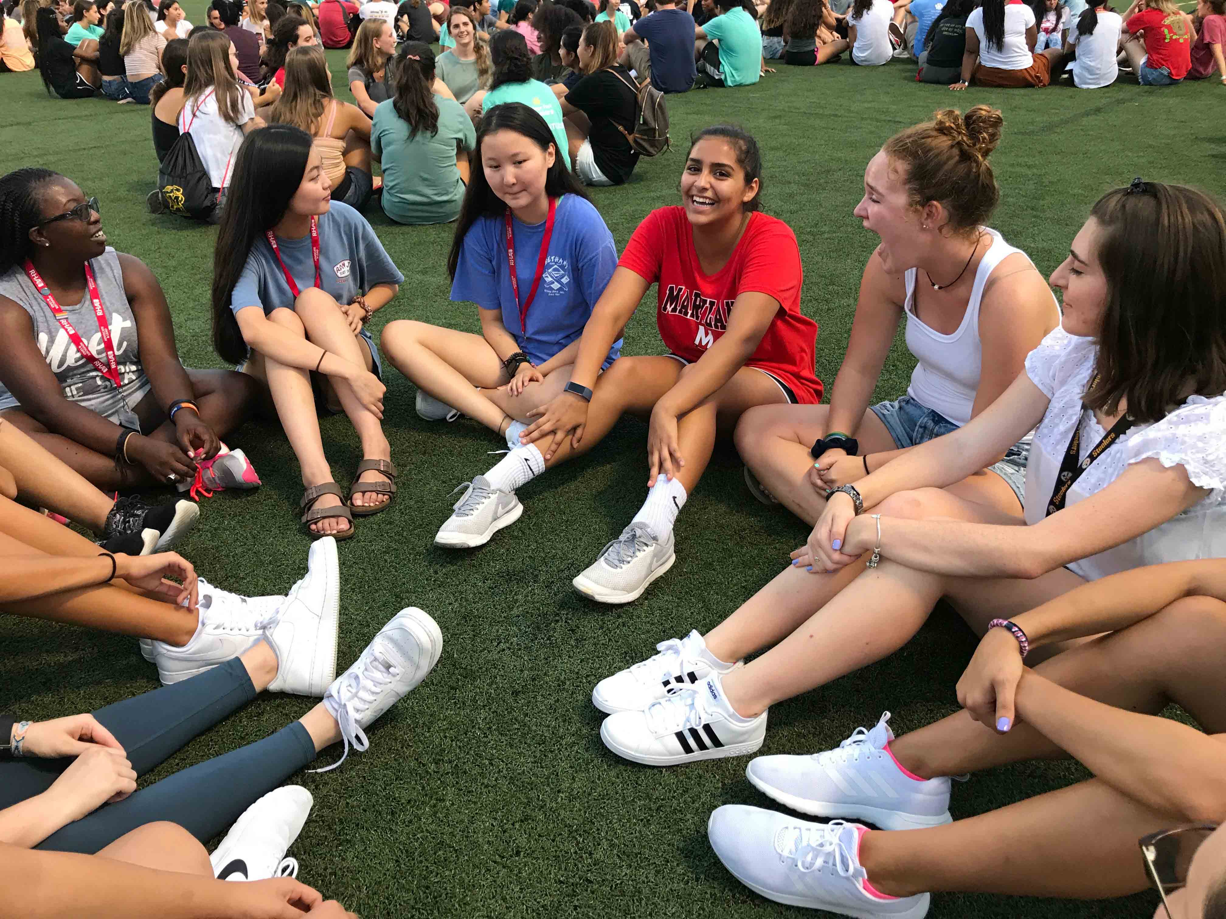 Smiling female students sit in a circle