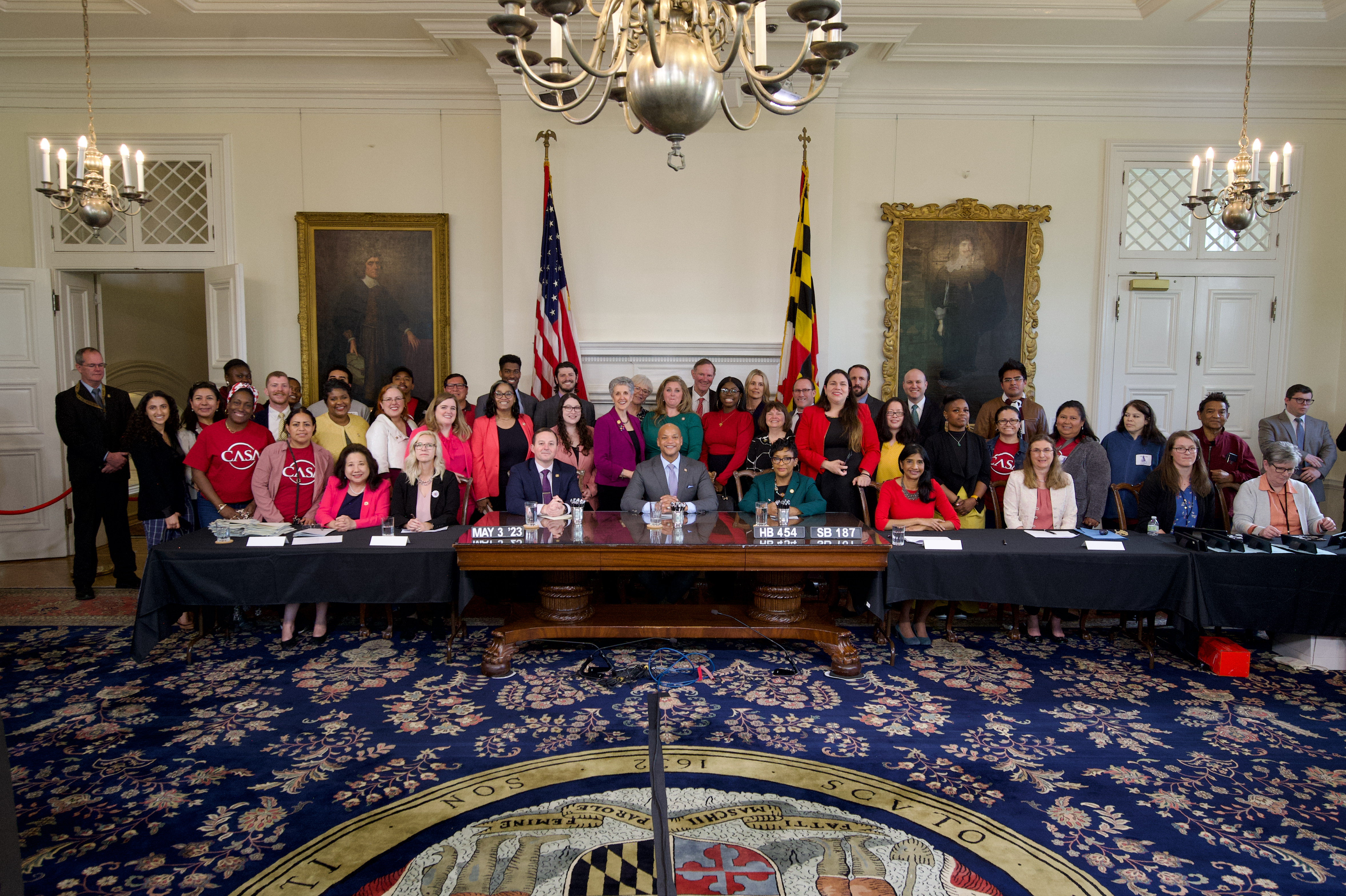 group photo at bill signing at Maryland State House with legislators, governor and others
