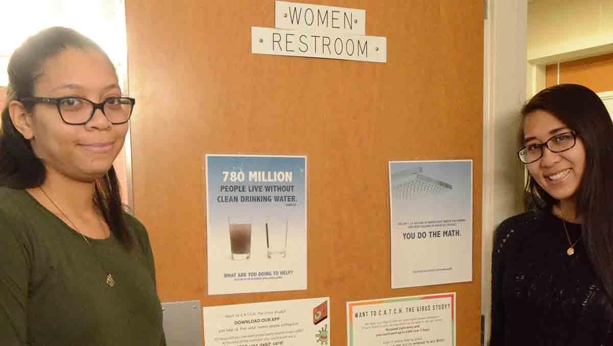 Women standing next to bathroom door