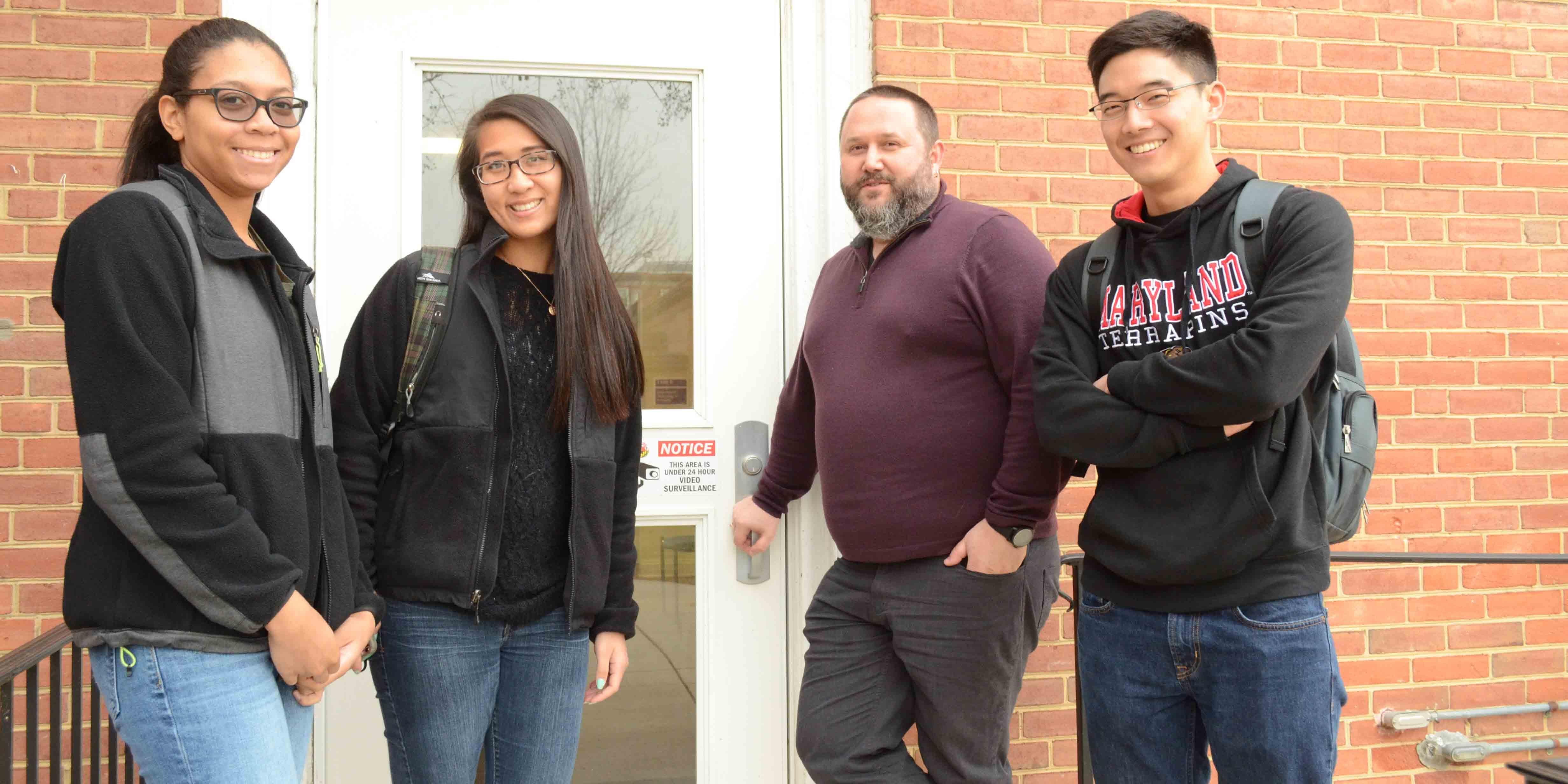 Program Director Tim Knight and Economy Scholars alumni Jada Mosley, Tiffany Wun and William Ma 