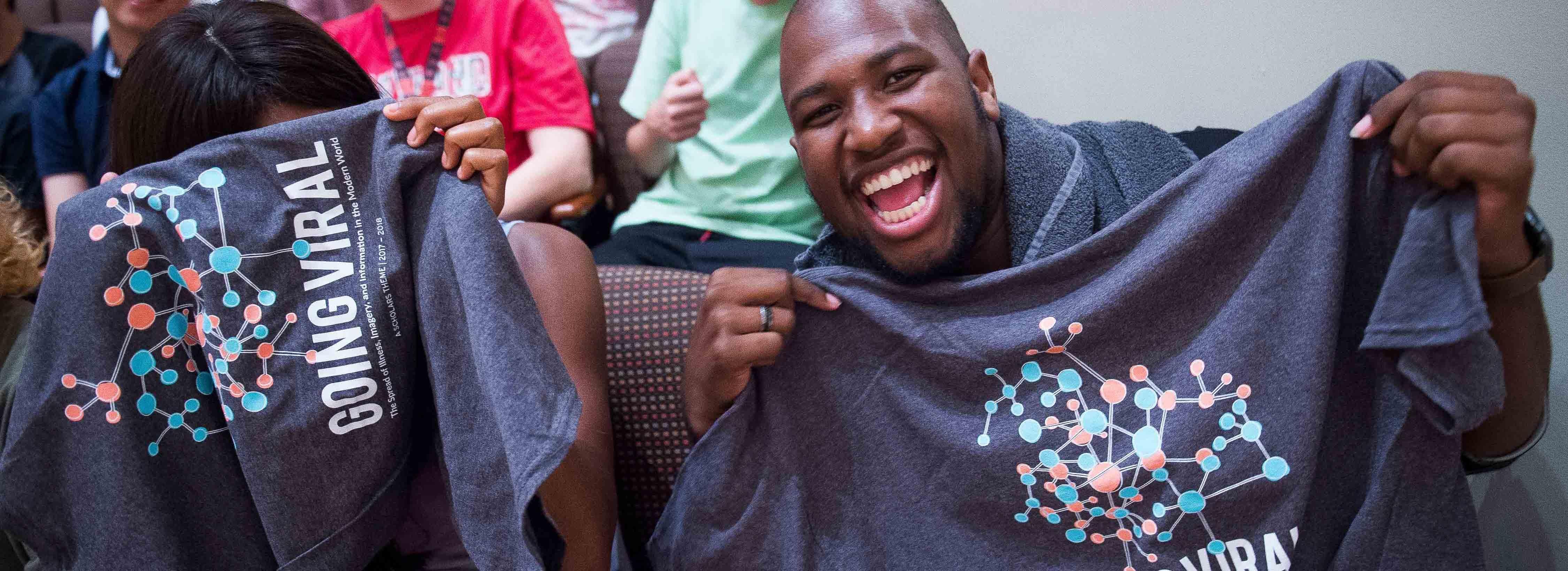 Students holding theme shirts