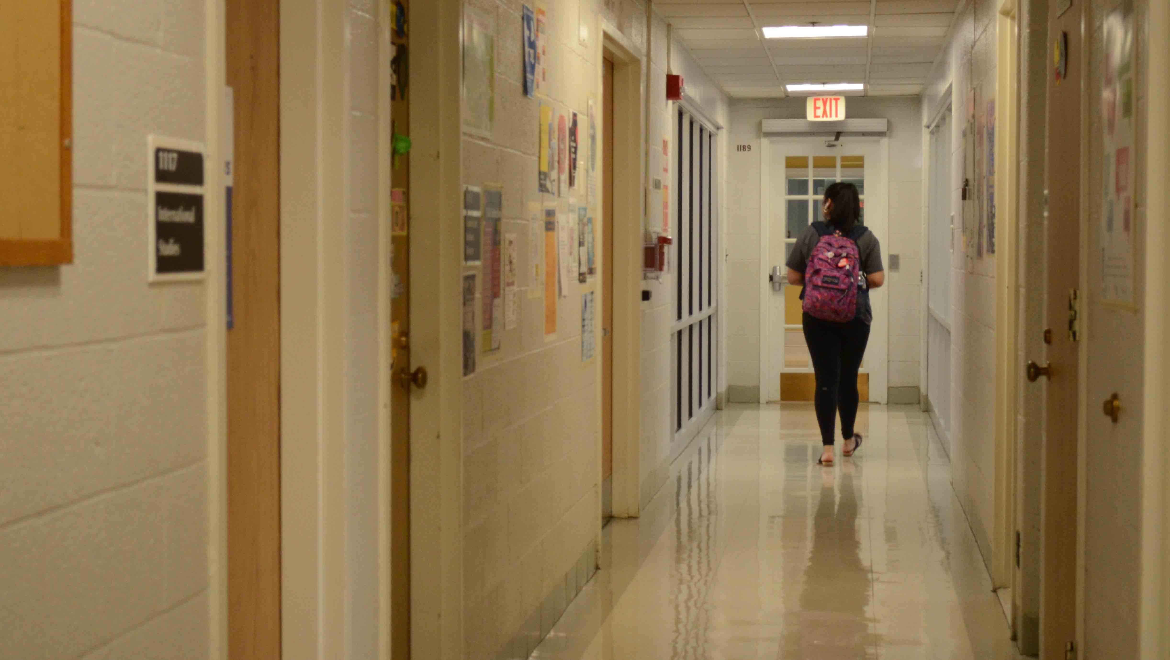 Marlen Cruz walking down a hallway