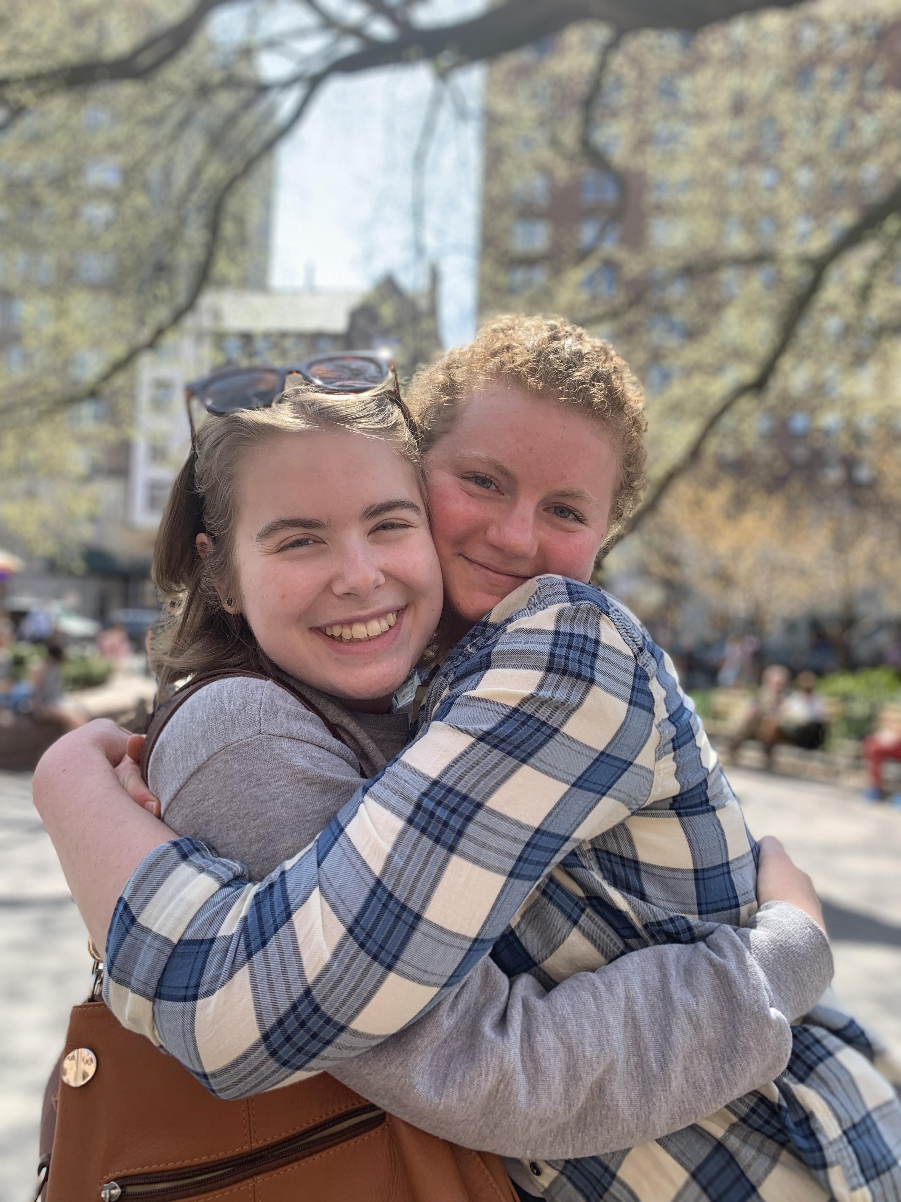 two students hug