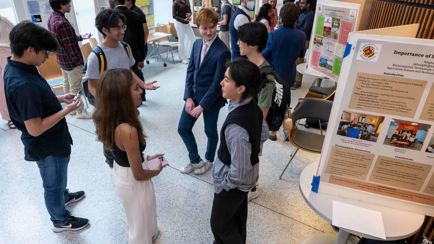 scholars fill Edward St. John building with posters and chat in groups