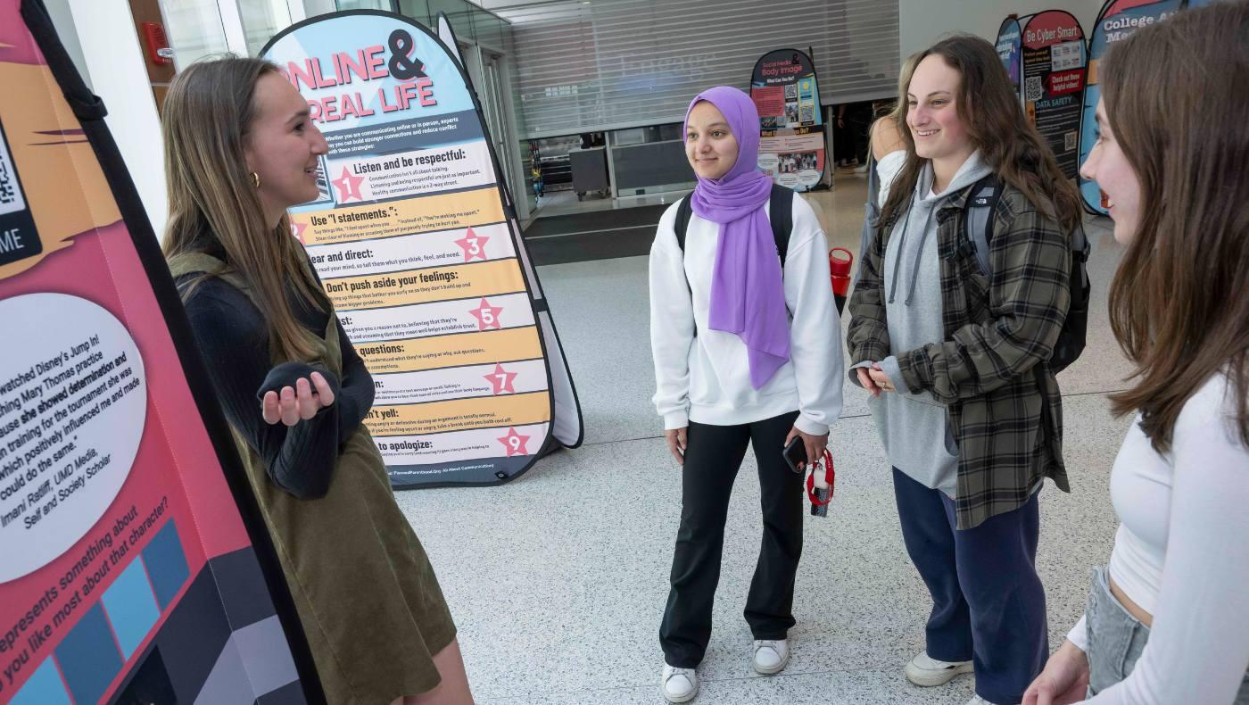 students look at media scholars displays