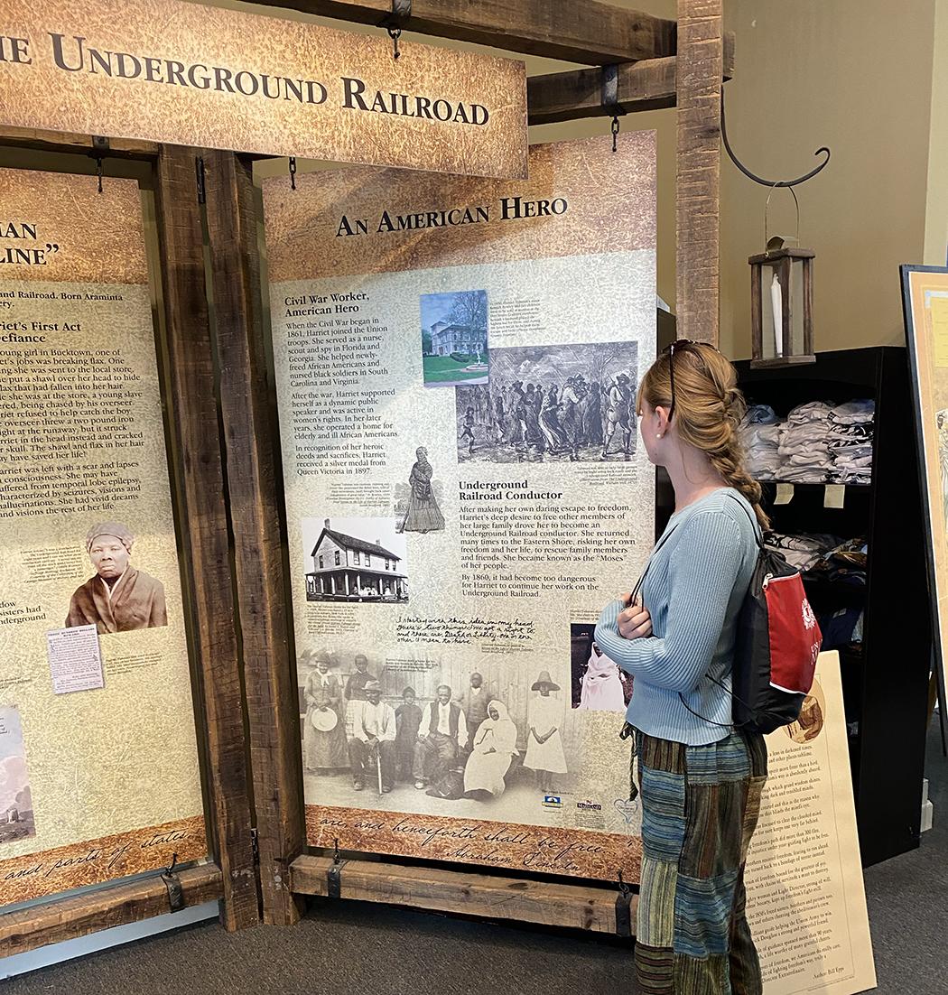student standing in front of underground railroad sign