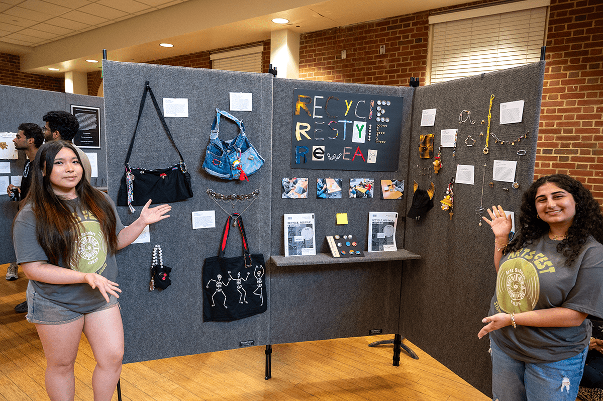 students standing on both sides of a gray presentation board