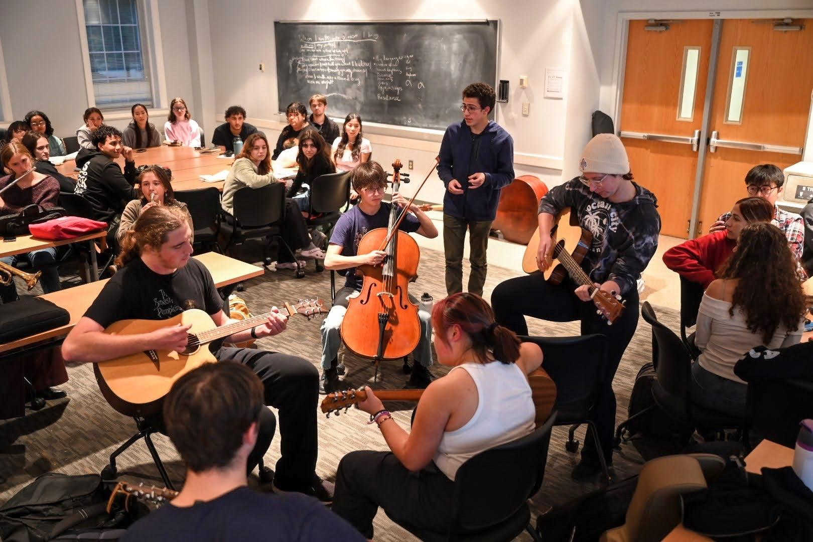 students seated in a classroom playing various instruments