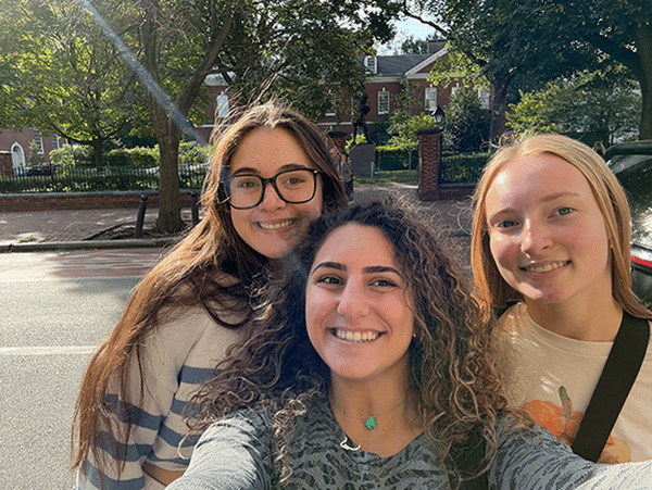 three women smiling at the camera