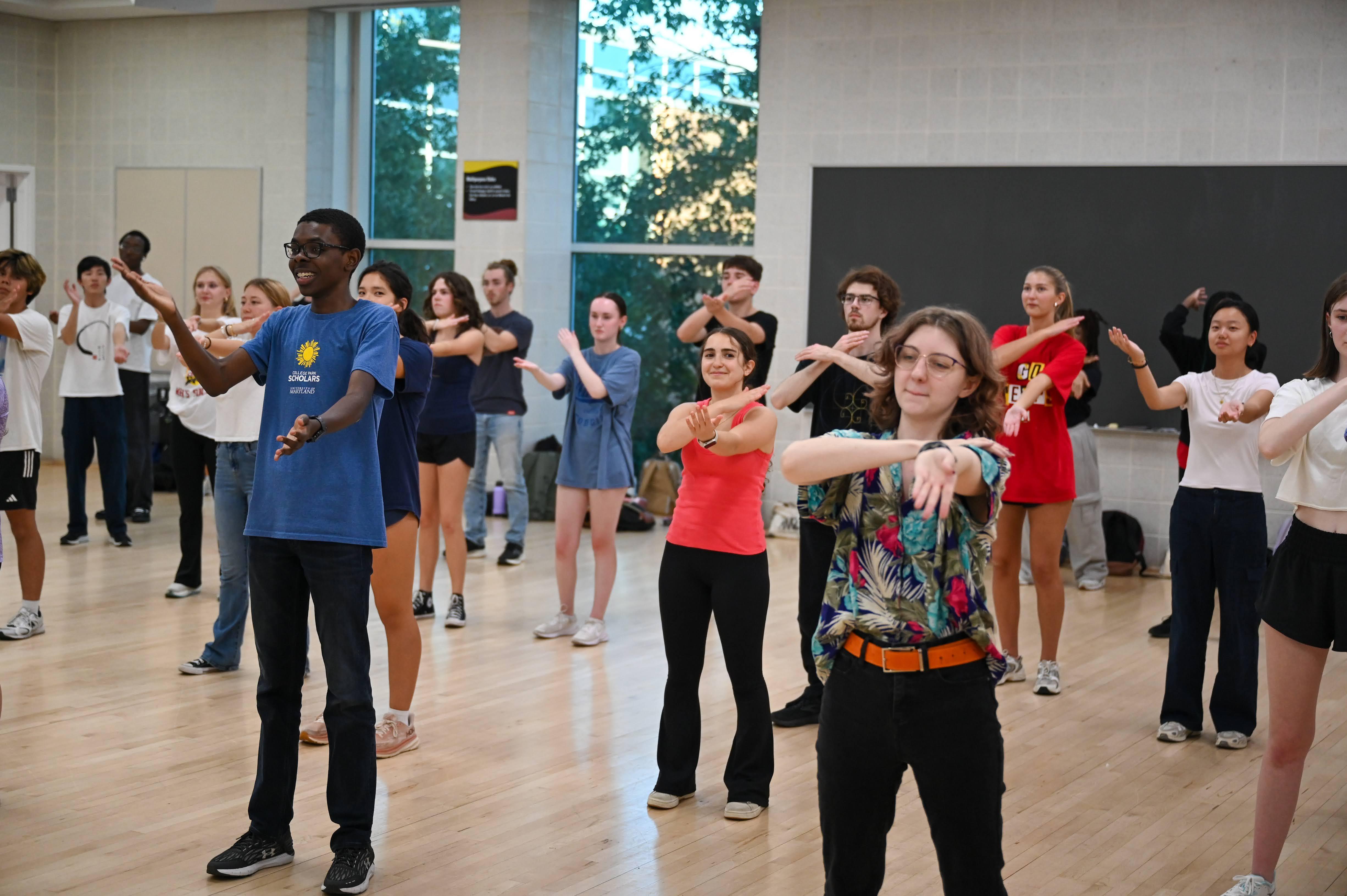 male and female students practicing dance moves