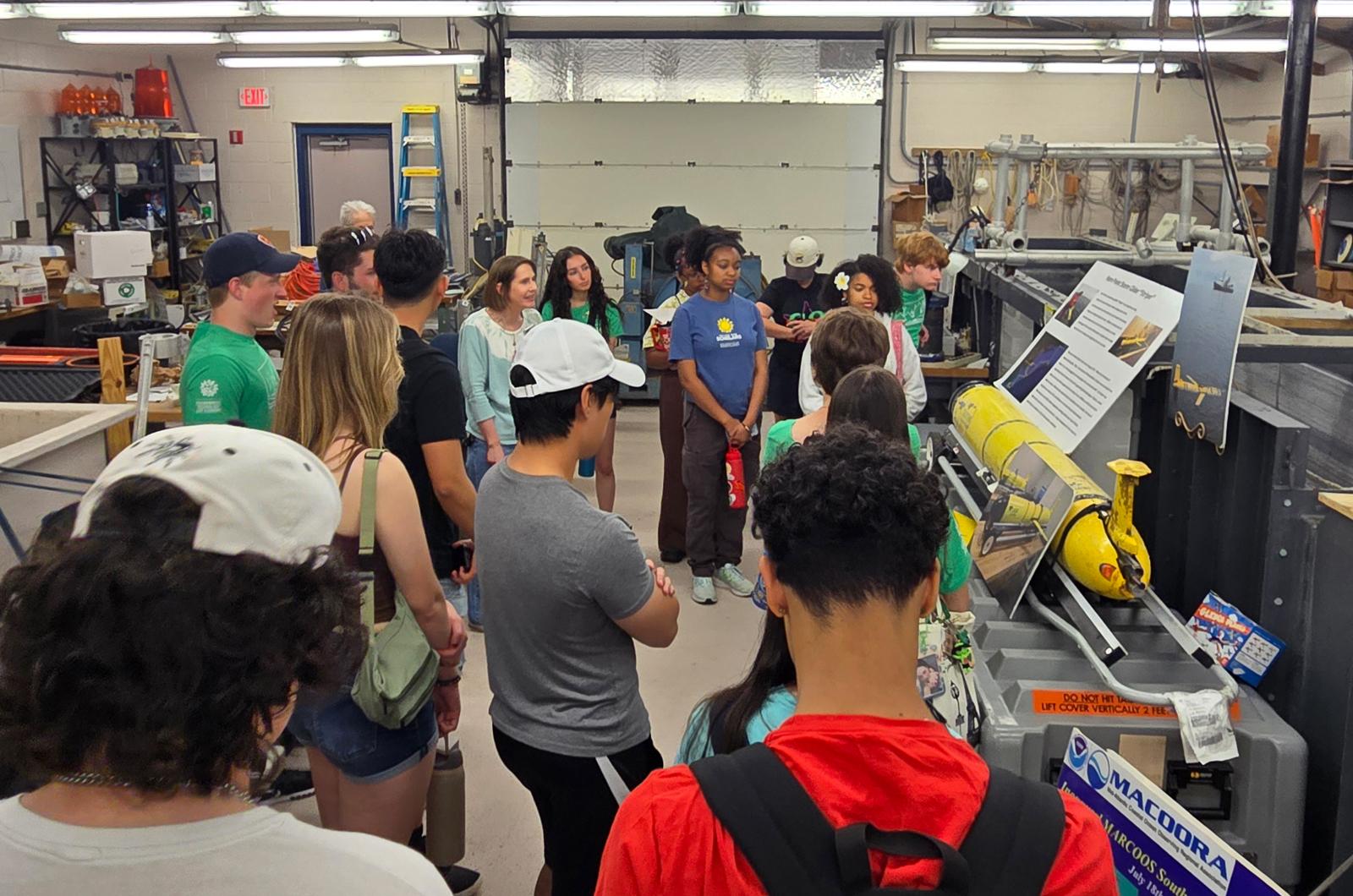 students stand around a yellow sea instrument