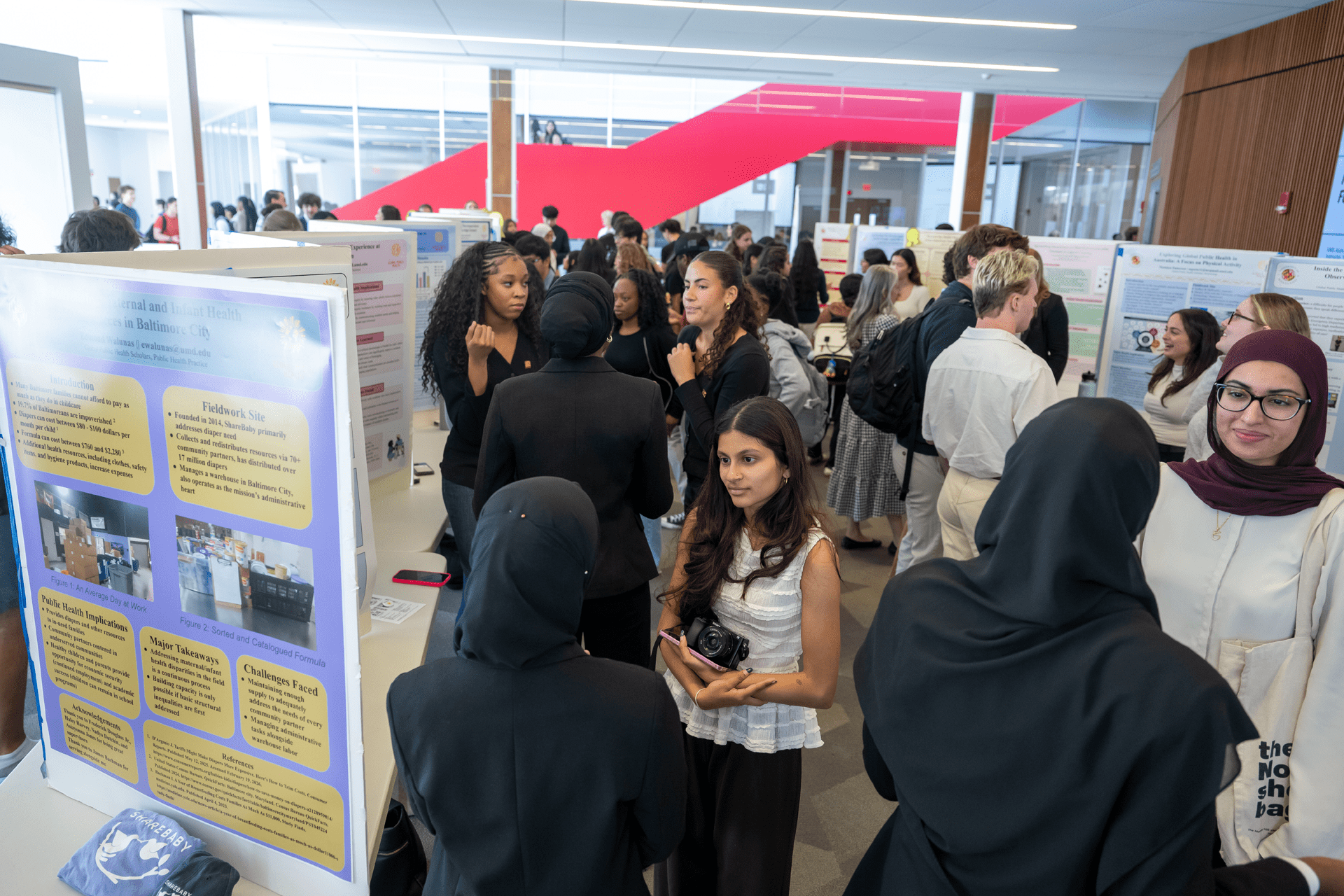 students standing between rows of poster boards