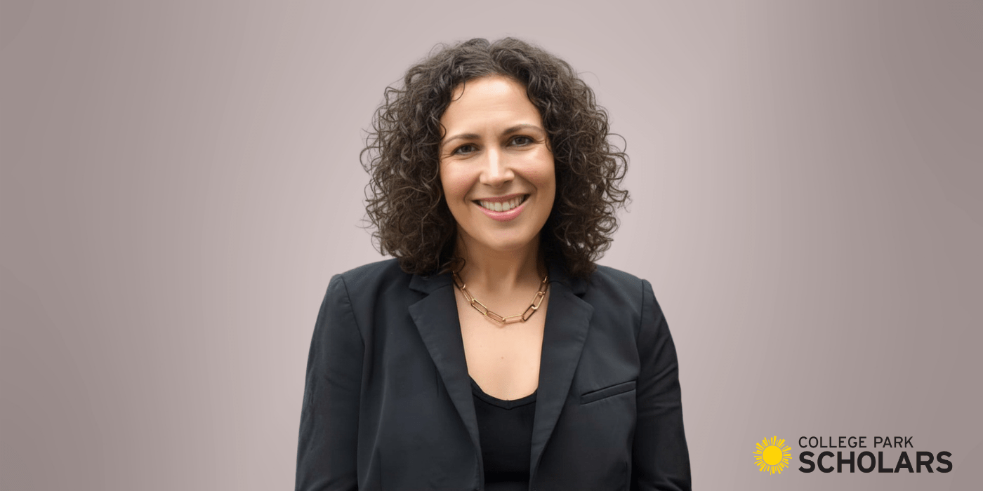 woman in black jacket and top smiling 